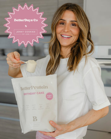 Woman holding a 'BetterProtein Birthday Cake' bag with 'BetterDays Co' and 'Jenny Cookies' branding.