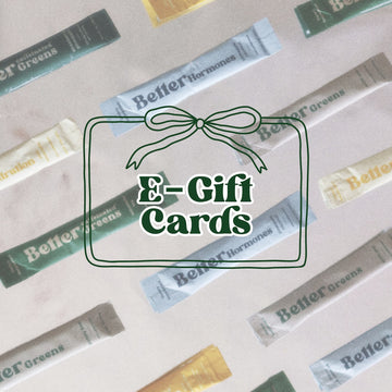 “E-Gift Cards” text inside a bow frame over a background of BetterGreens and BetterHormones packets.