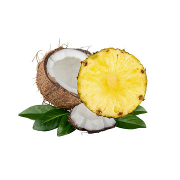 Halved coconut and sliced pineapple with green leaves on a white background