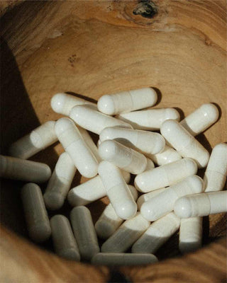 Capsules in a wooden bowl